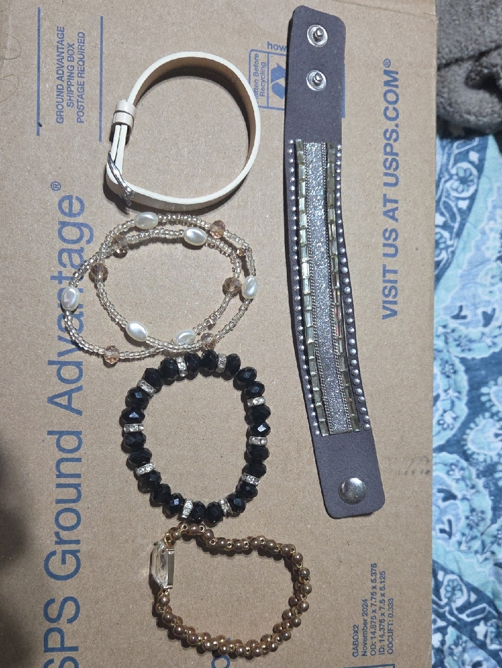 Set of Women's Layered Bracelets in Black, Gold, Cream
